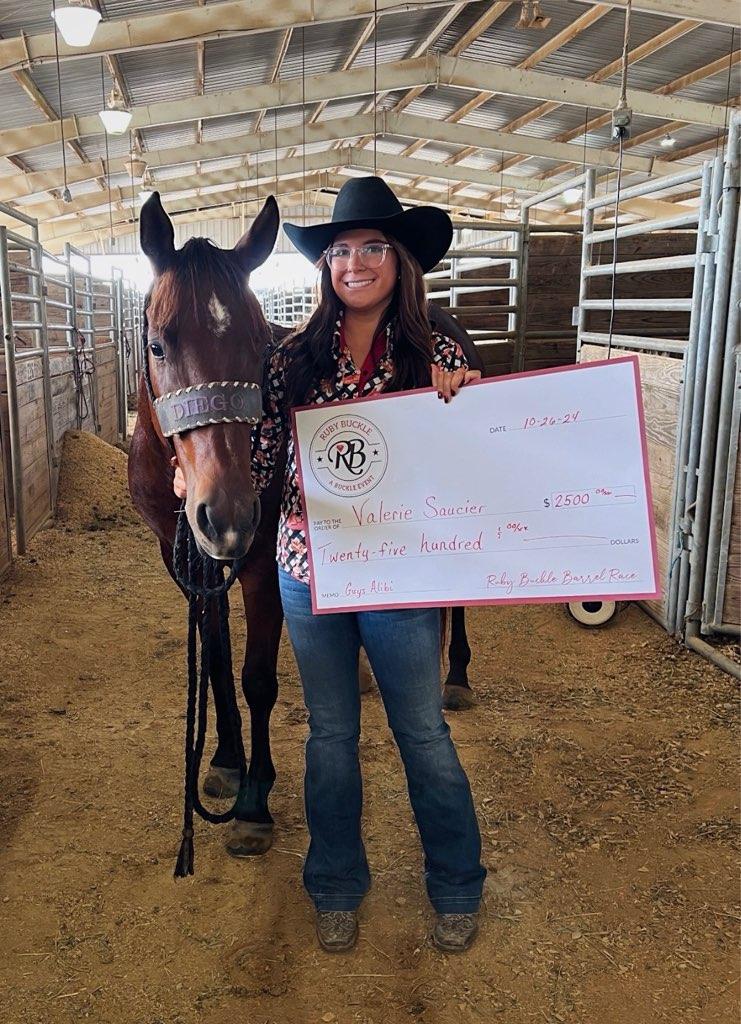 Valerie Saucier accepting a winner's check at the Ruby Buckle